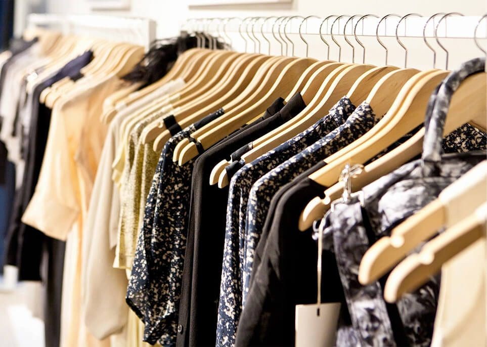 A row of clothes hanging on the rack.