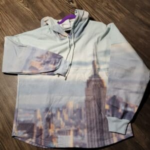 A shirt that is on the ground with pictures of buildings.